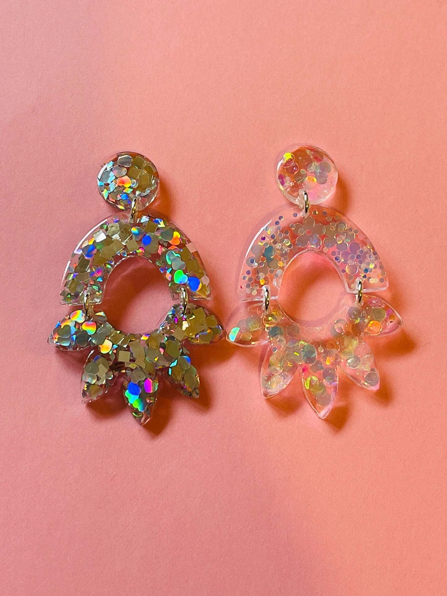 Form for epoxy. A set of earrings in the form of an arc and a flower Silicone mold. Jewelry pendant from a casting mold. Glossy resin mold.
